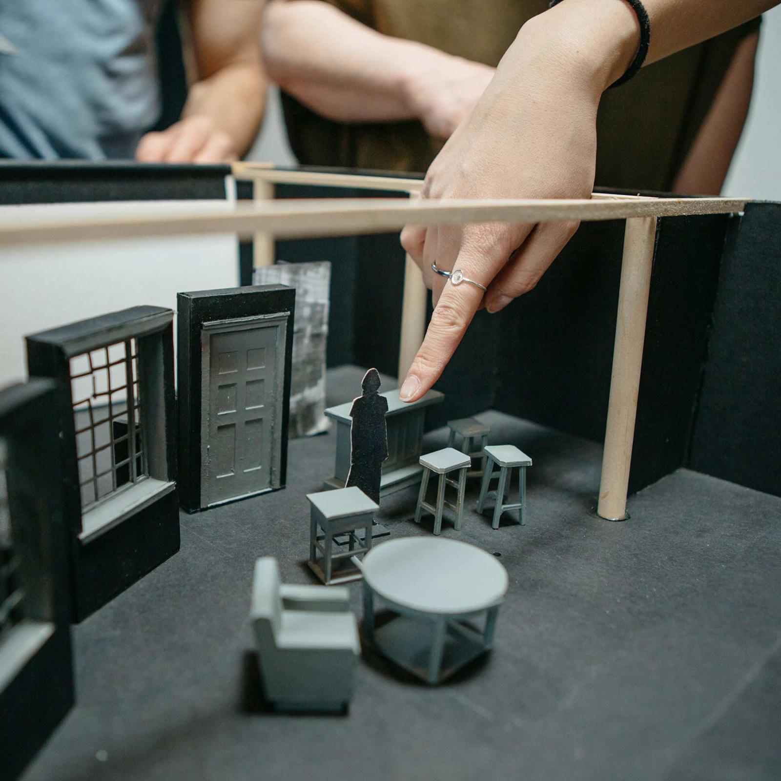 Pace University Film and Screen Studies students setting a scene with a small replica set