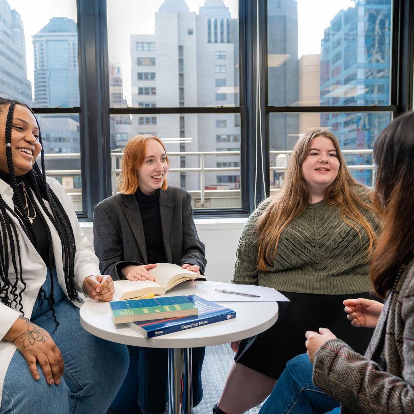 Pace University Publishing students and alumni sitting together at a table talking