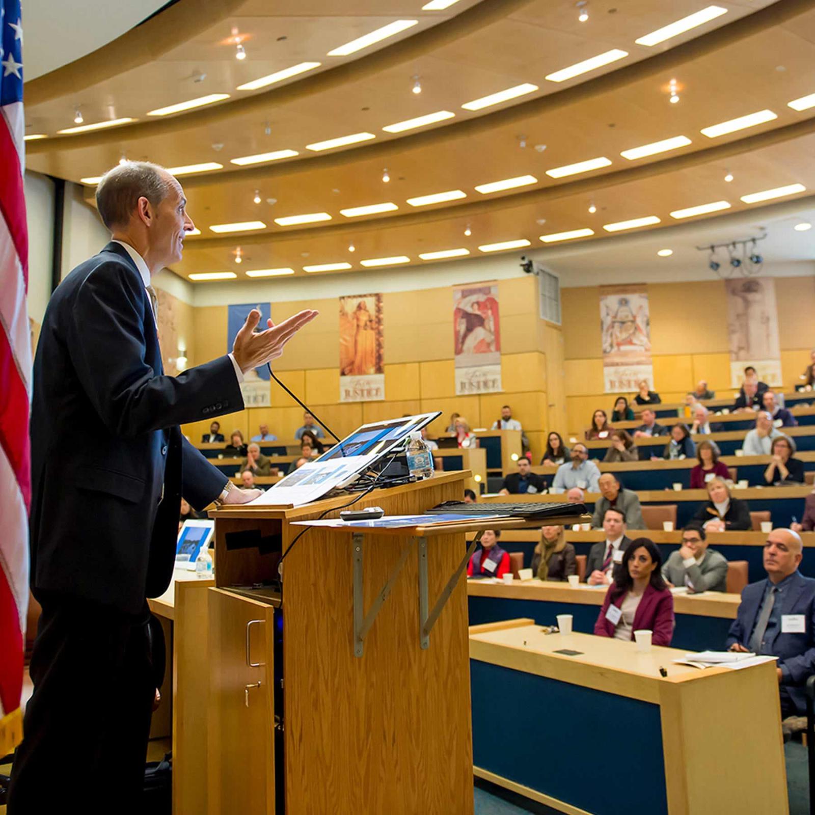 Man speaking in a lecture hall at the Elisabeth Haub School of Law