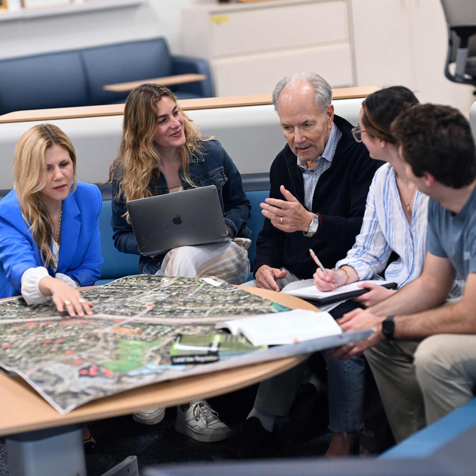 John Nolon, Distinguished Professor of Law Emeritus at Elisabeth Haub School of Law and Co-Counsel, Land Use Law Center at Elisabeth Haub School of Law, Jennie C. Nolon Blanchard, Senior Staff Attorney, Land Use Law Center and Adjunct Professor, and students reviewing a map