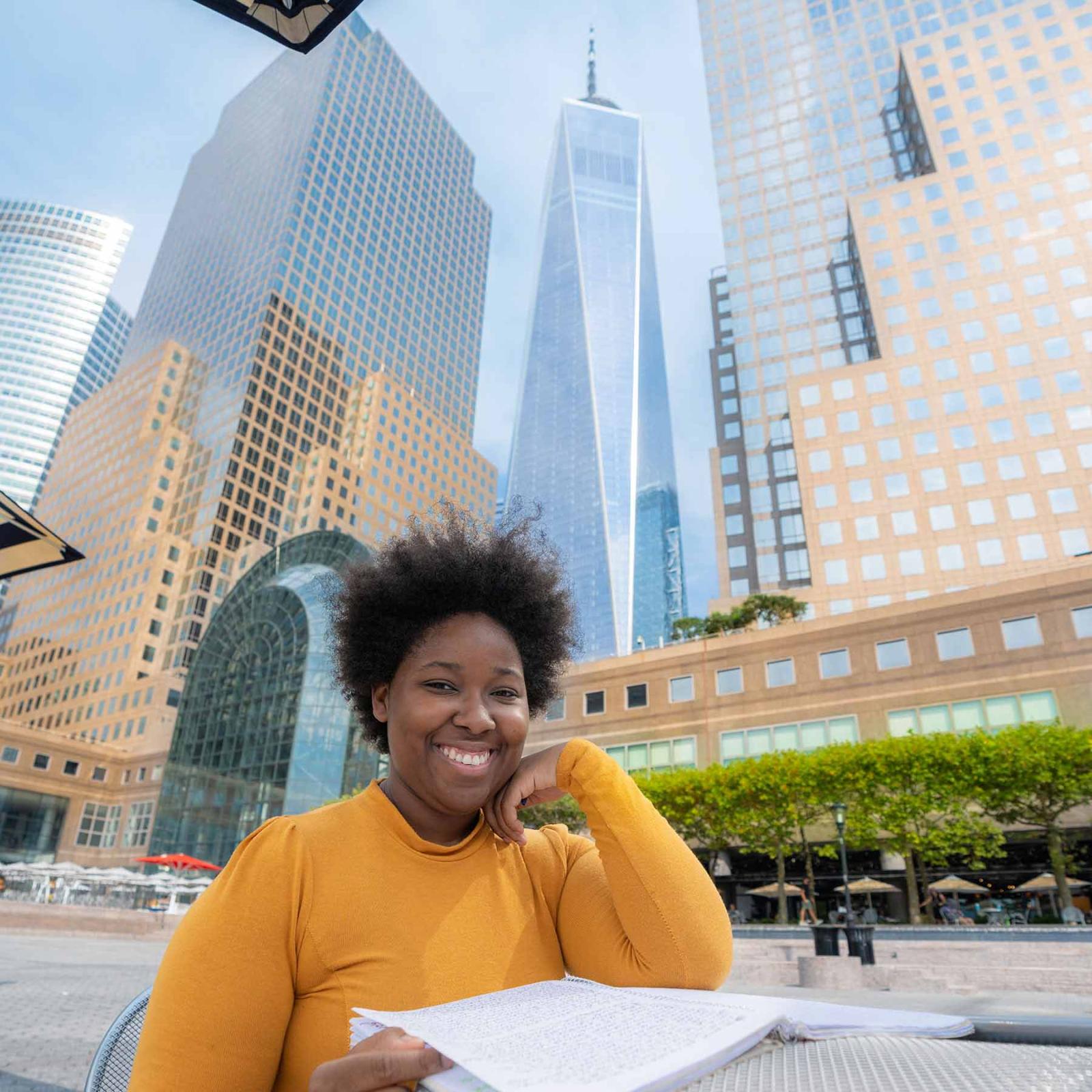 Pace University student sitting at a table, studying, in NYC.