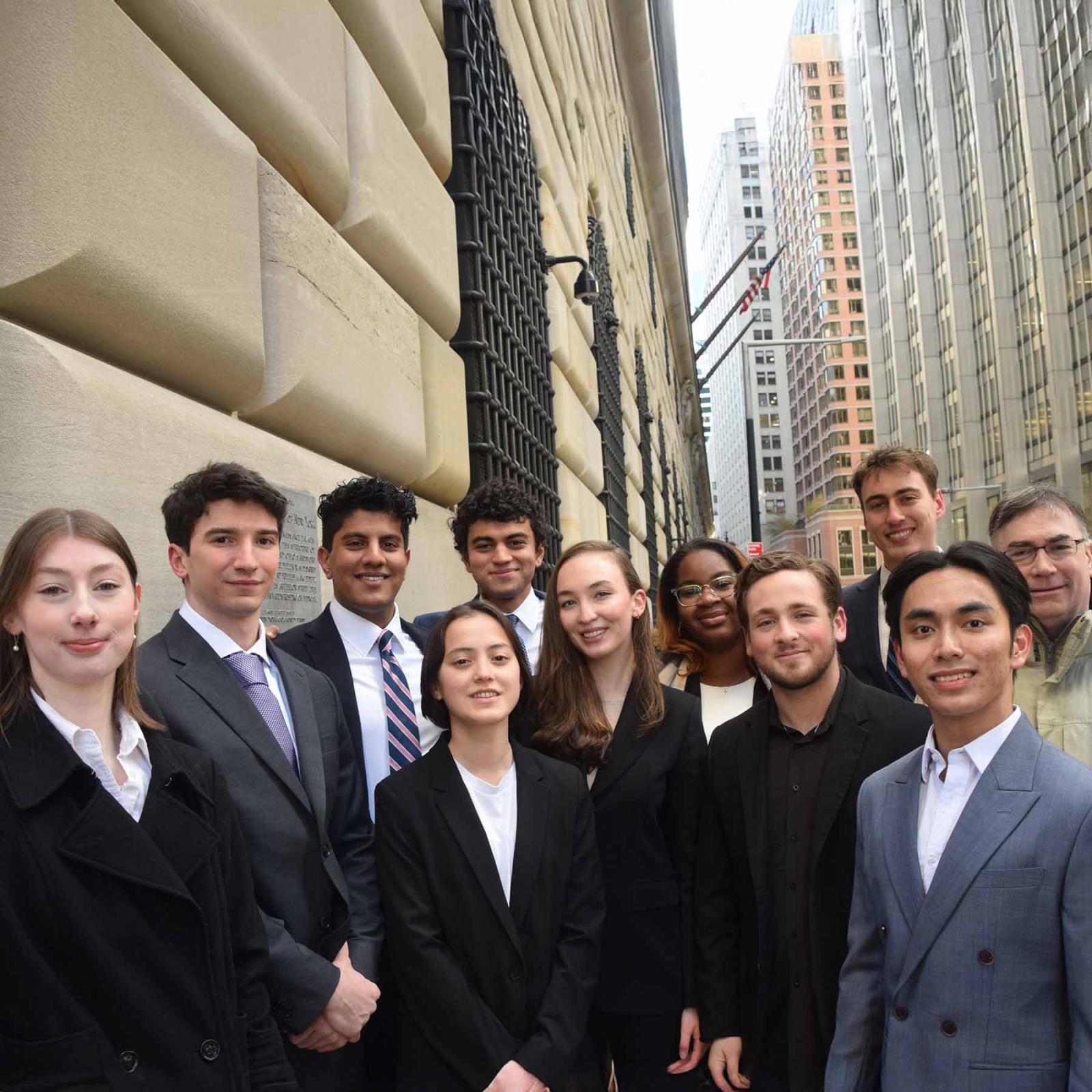 The Pace University Federal Reserve Challenge team standing outside after winning the New York Regional College Federal Reserve Challenge competition