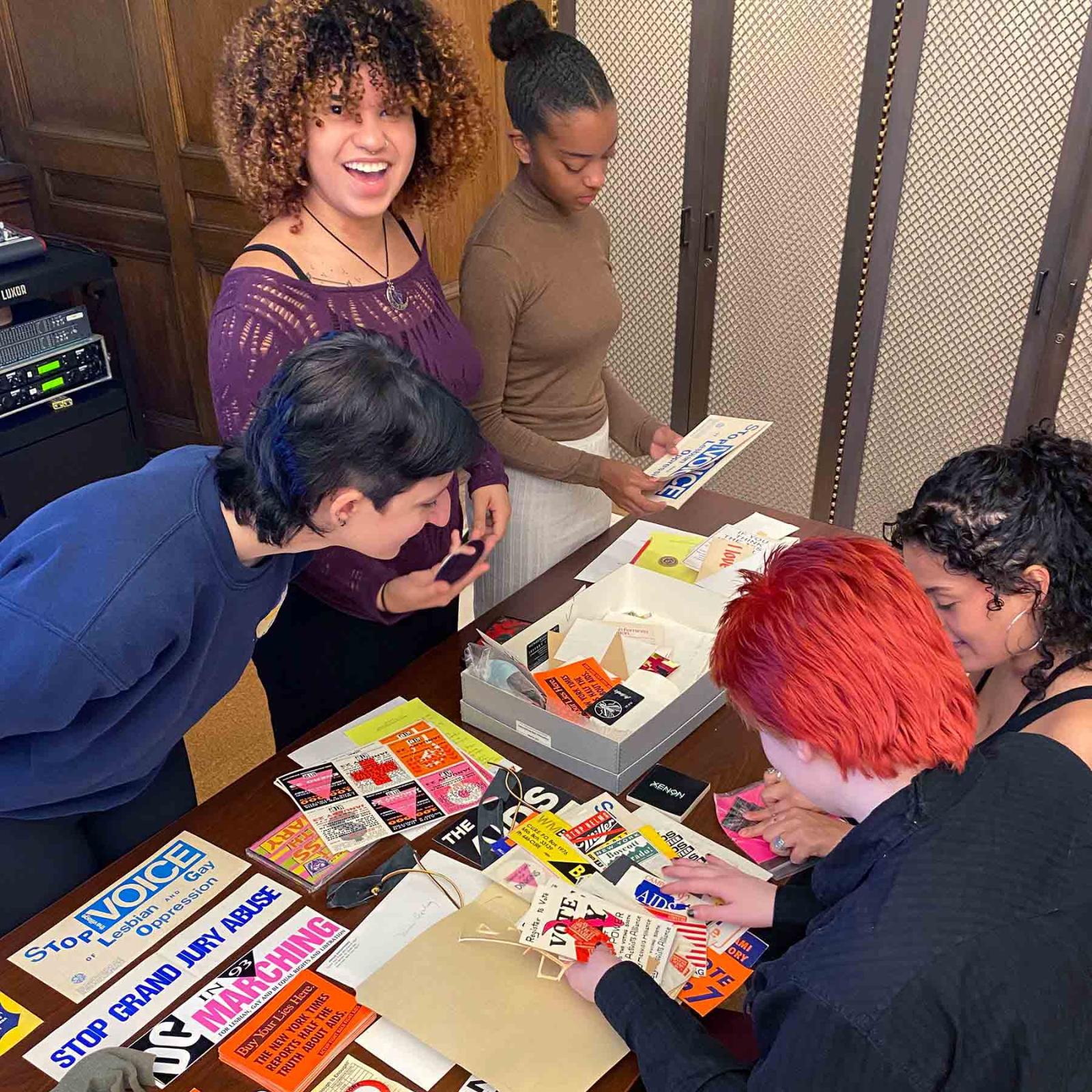 Several Pace University Women's and Gender Studies students looking over protest and advocacy materials