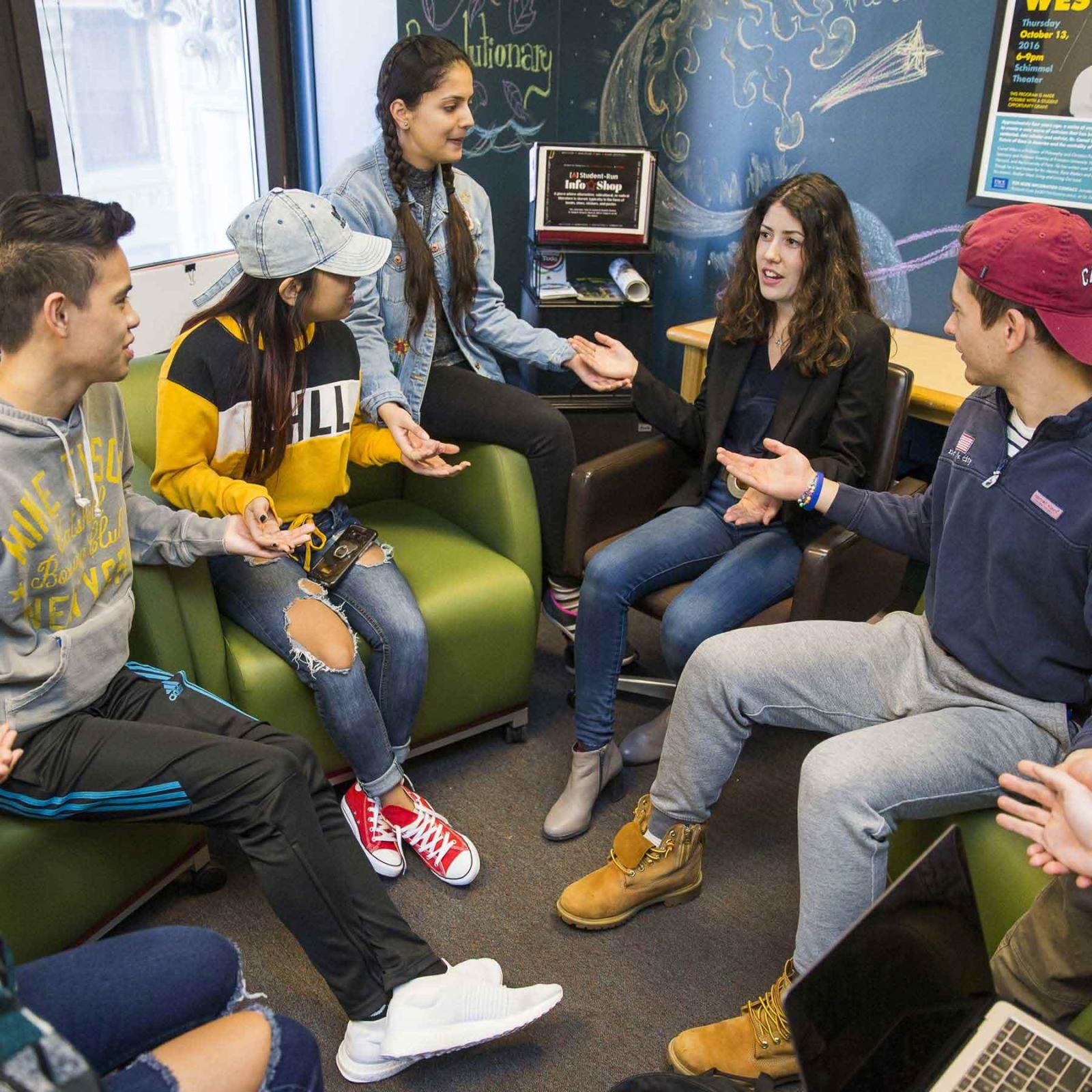 Students sitting on couches talking and laughing.
