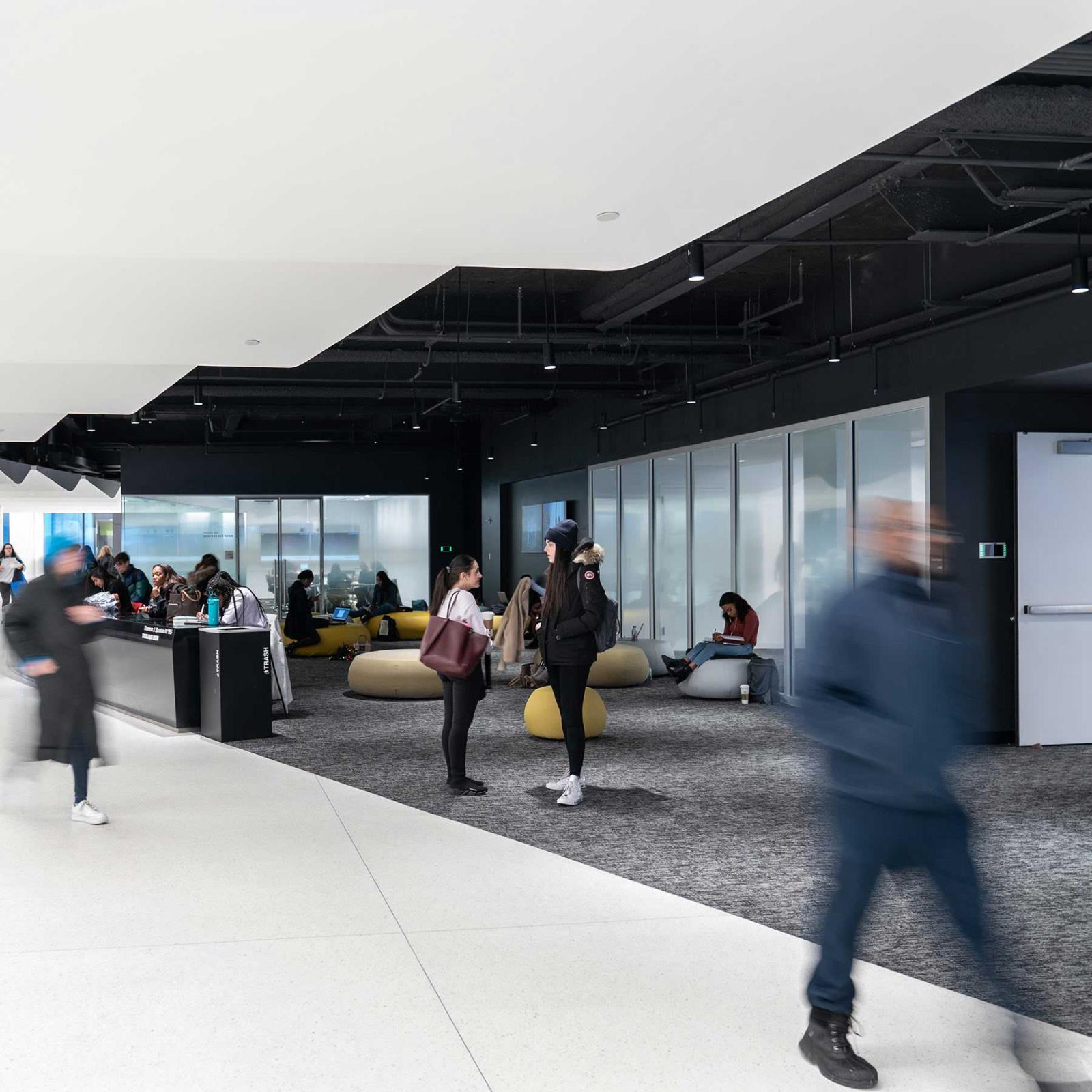Students walking through the halls of One Pace Plaza on the Pace University NYC campus.