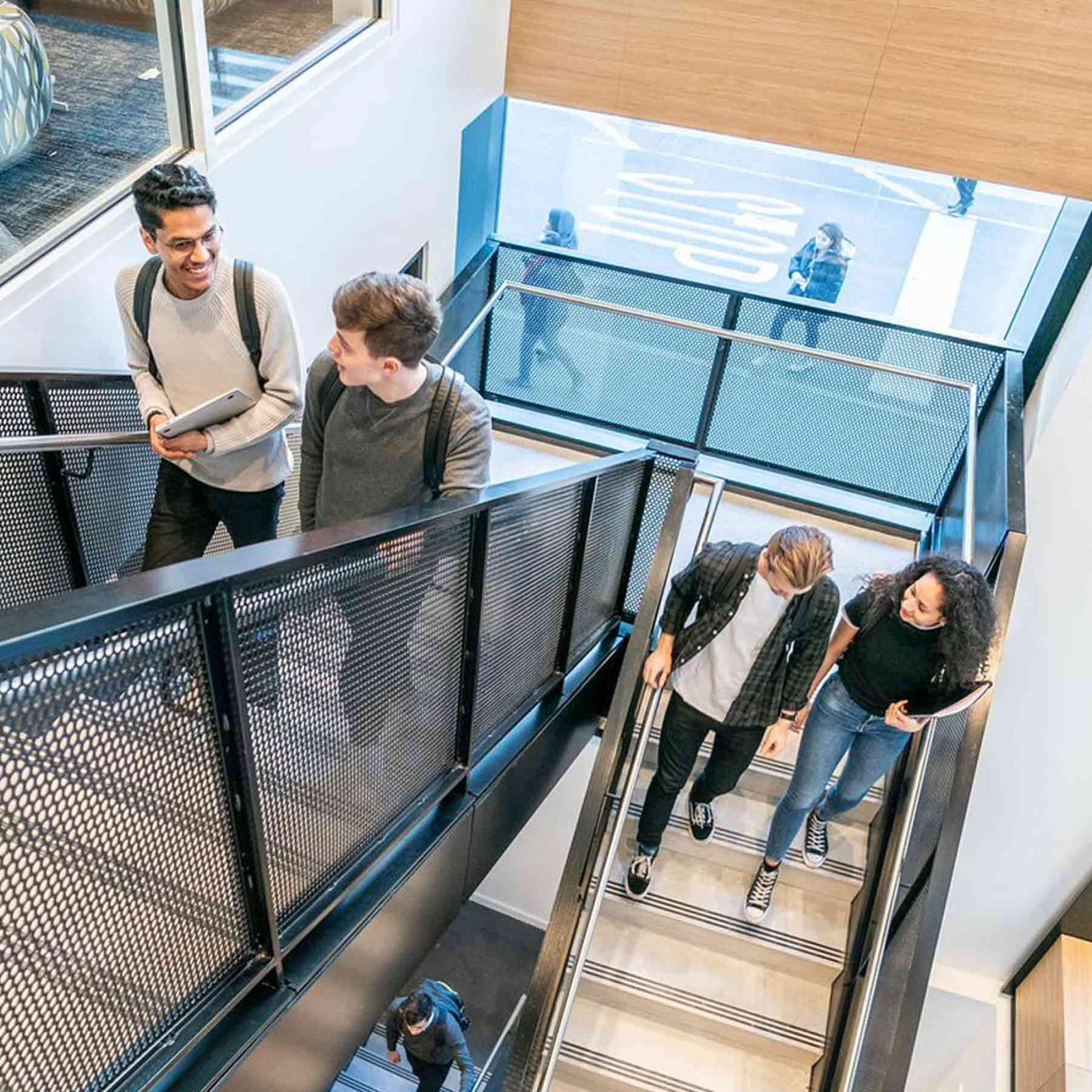 Students walking down a staircase.