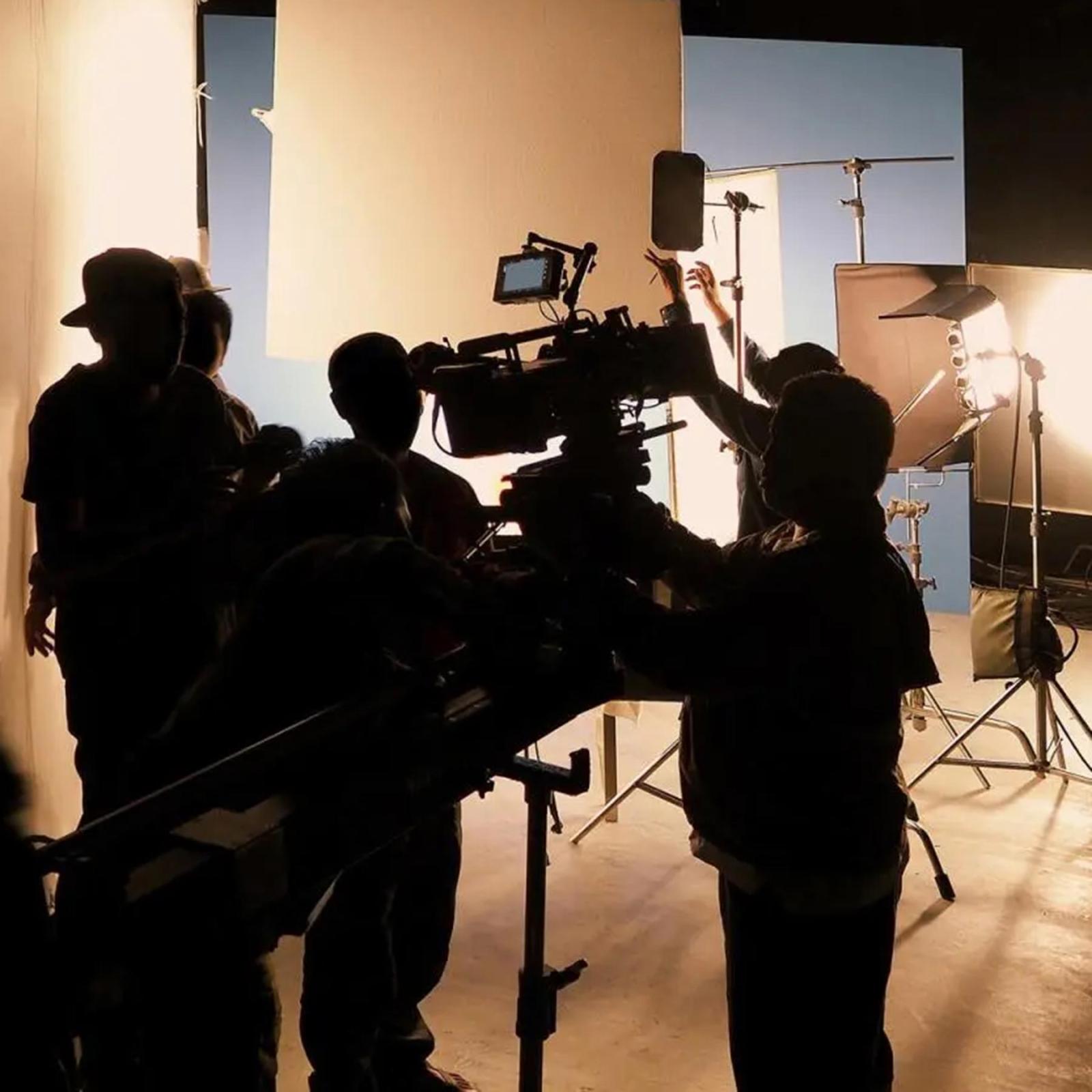 Students working with lighting and cameras on a photoshoot