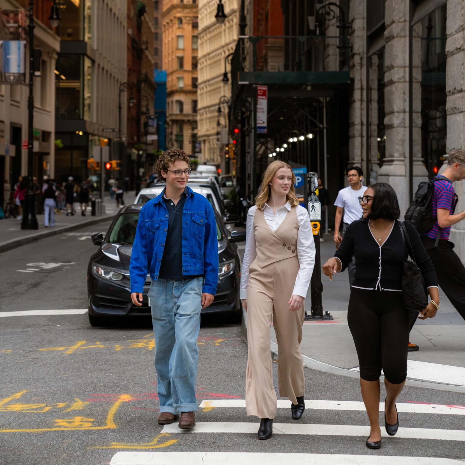 Three Pace University students walking around NYC.
