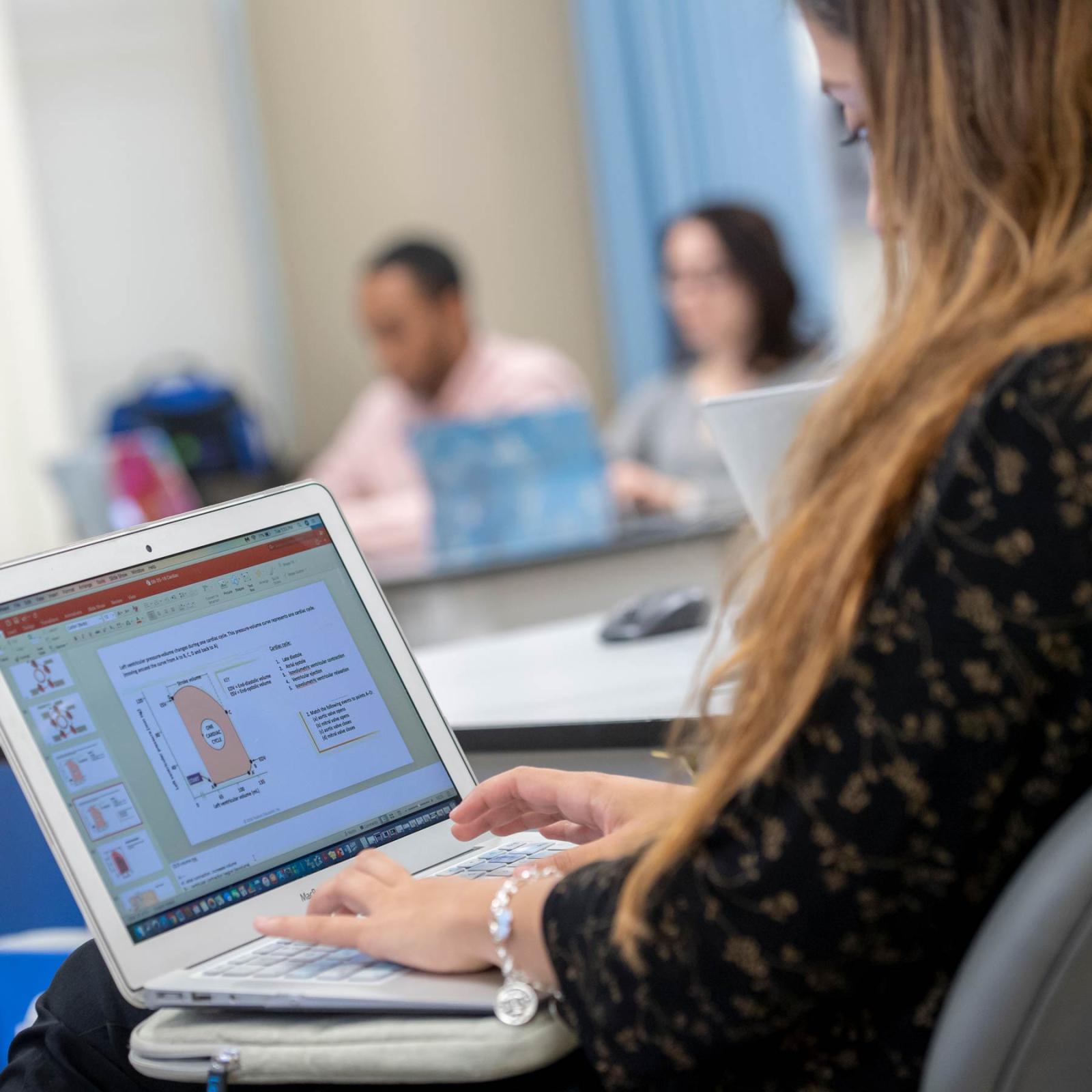 Pace University professor teaching a class on her laptop.