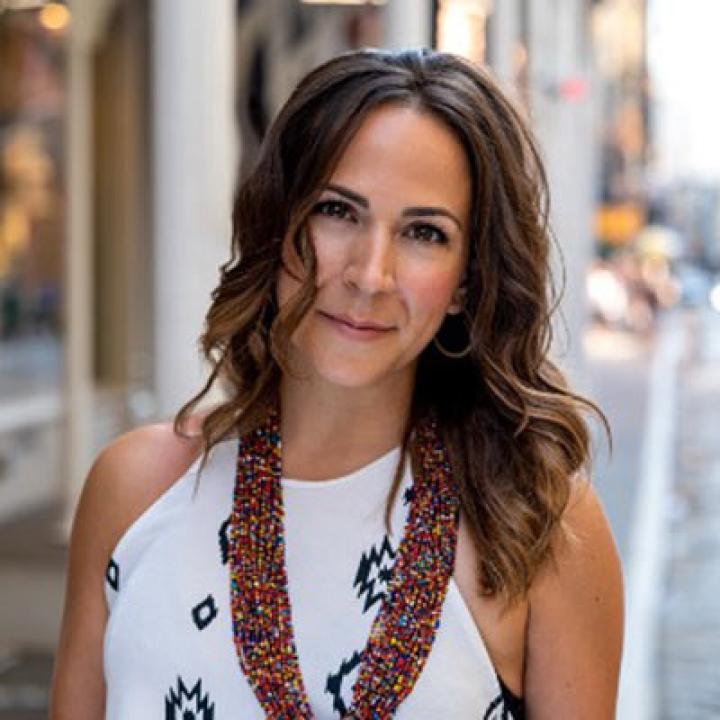 Portrait of Diana Lote wearing a white sleeveless shirt with several beaded necklaces