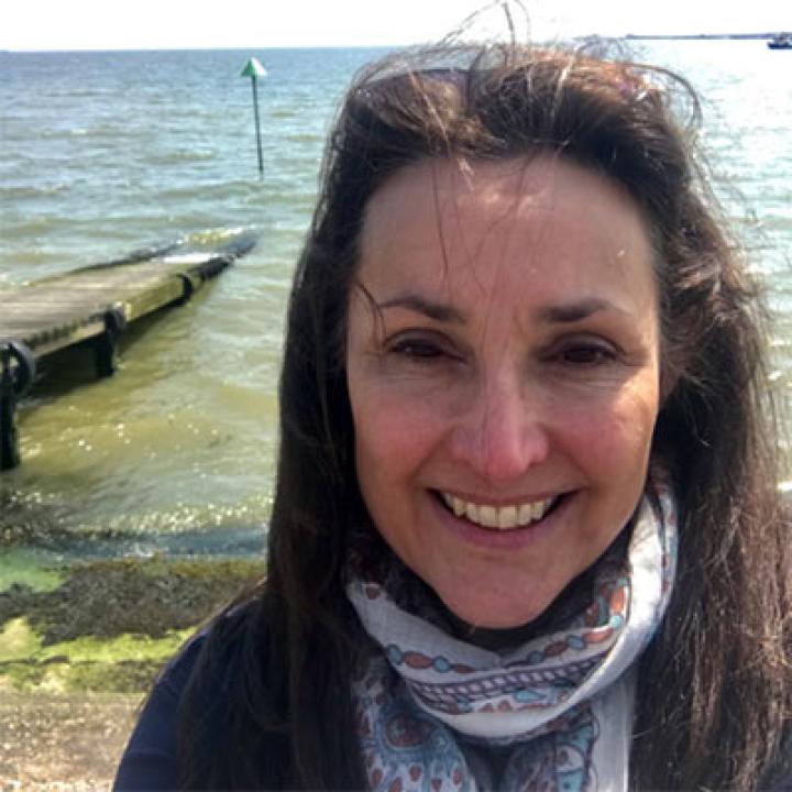 Portrait of Nora Leonhardt wearing a scarf with water in the background