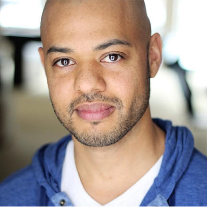 Portrait of Ryan Quinn wearing a blue hoodie over a white shirt